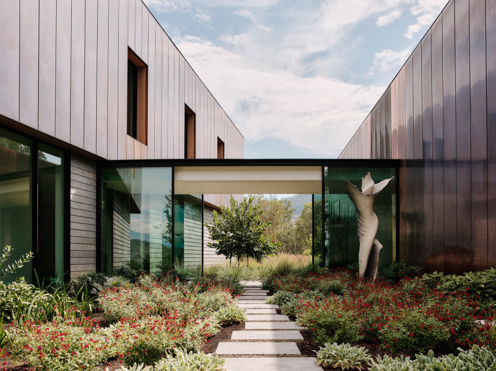 Foto de fachada de casa marrón minimalista extra grande de dos plantas con revestimientos combinados y tejado de varios materiales