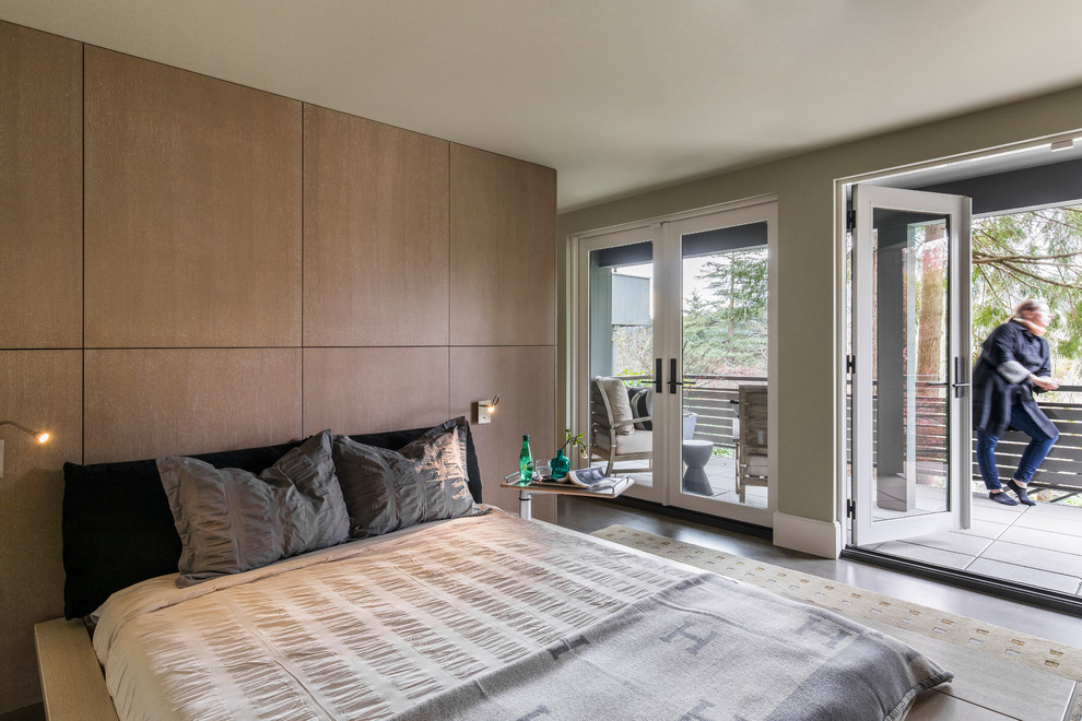 This is an example of a mid-sized modern master bedroom in Portland with green walls and concrete floors.