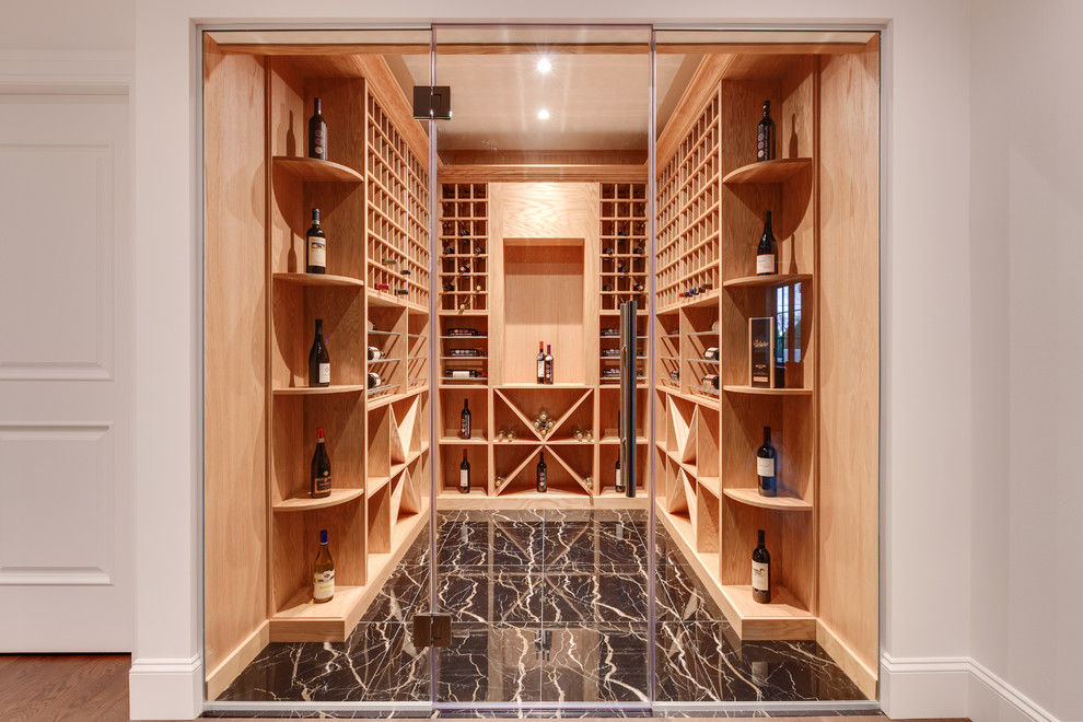 Contemporary wine cellar in Vancouver with storage racks and black floor.