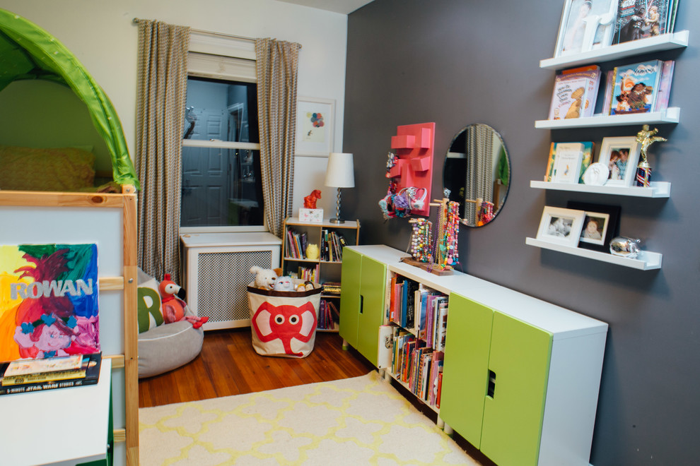 Photo of a small contemporary kids' bedroom for kids 4-10 years old and girls in New York with grey walls, dark hardwood floors and brown floor.