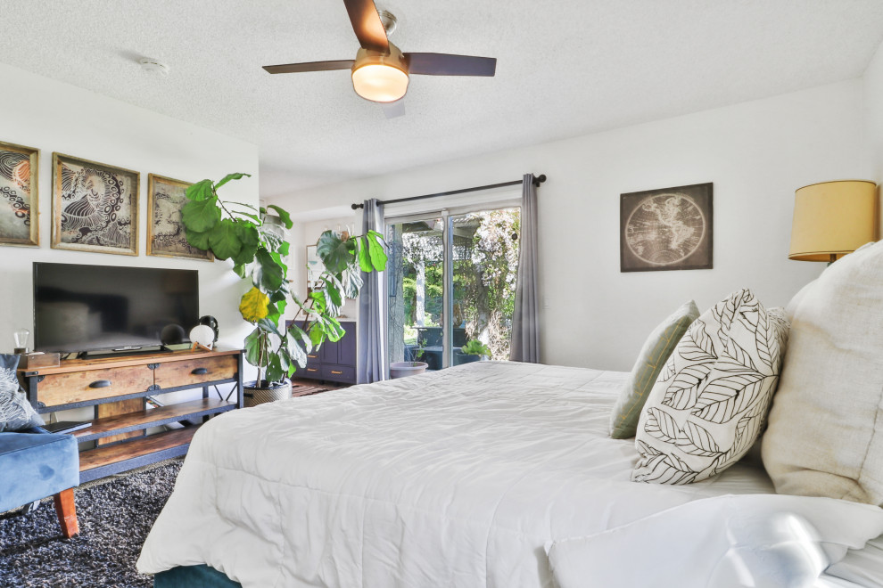 Inspiration for a mid-sized transitional master dark wood floor and brown floor bedroom remodel in Los Angeles with gray walls