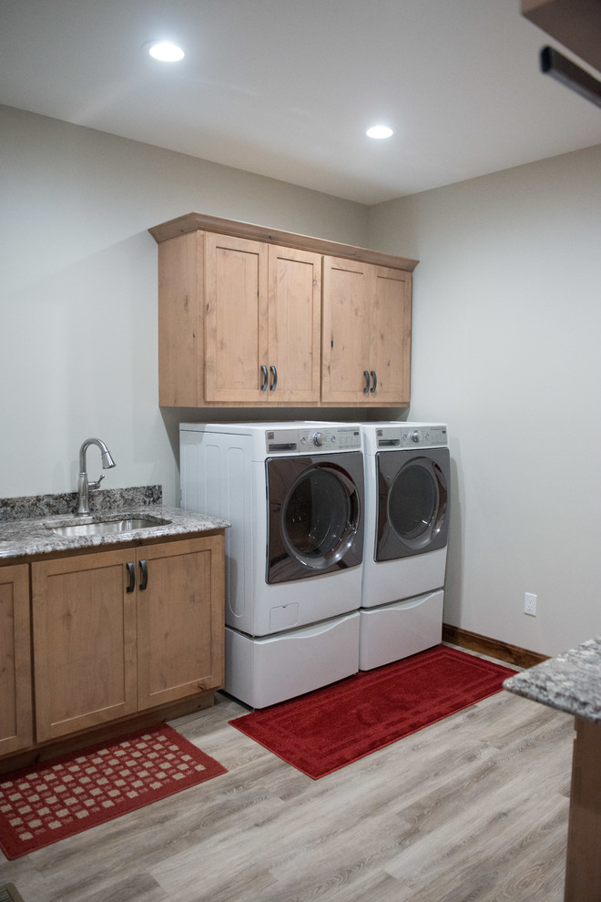 Utility room - large rustic u-shaped laminate floor utility room idea with an undermount sink, shaker cabinets, light wood cabinets, granite countertops, white walls, a side-by-side washer/dryer and multicolored countertops