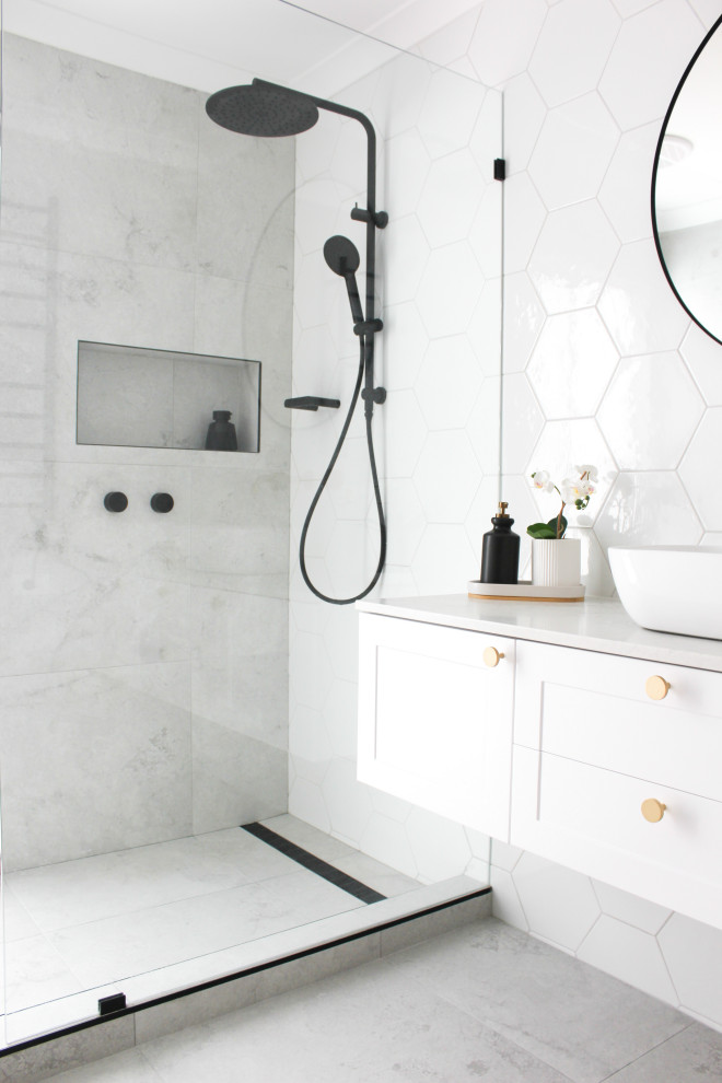 Large master bathroom in Perth with shaker cabinets, white cabinets, an open shower, a one-piece toilet, white tile, ceramic tile, white walls, porcelain floors, a vessel sink, marble benchtops, grey floor, an open shower, grey benchtops, a niche, a single vanity and a floating vanity.