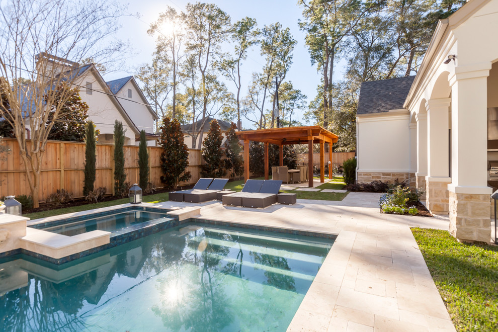 Example of a mid-sized transitional backyard tile and rectangular hot tub design in Houston