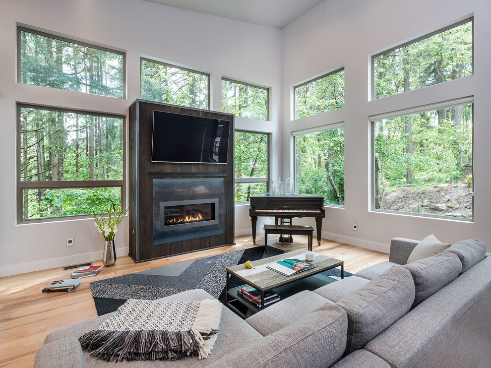 This is an example of a large modern open concept living room in Other with white walls, medium hardwood floors, a ribbon fireplace, a wall-mounted tv and beige floor.