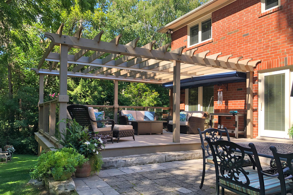 This is an example of a traditional backyard patio in Toronto with a pergola.