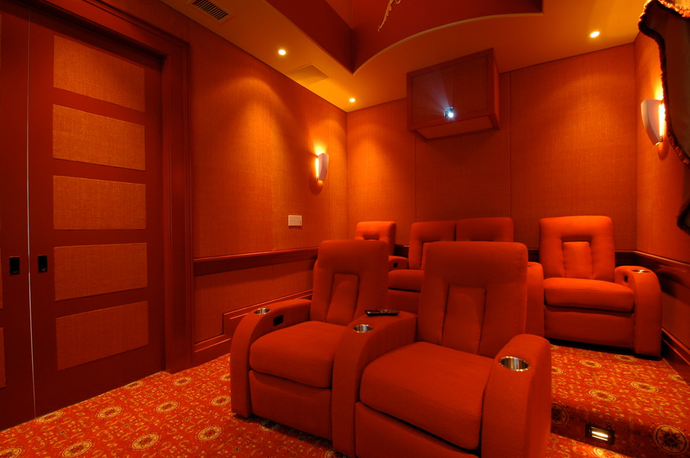 Inspiration for a mid-sized eclectic enclosed home theatre in Charleston with a projector screen, orange walls, carpet and orange floor.