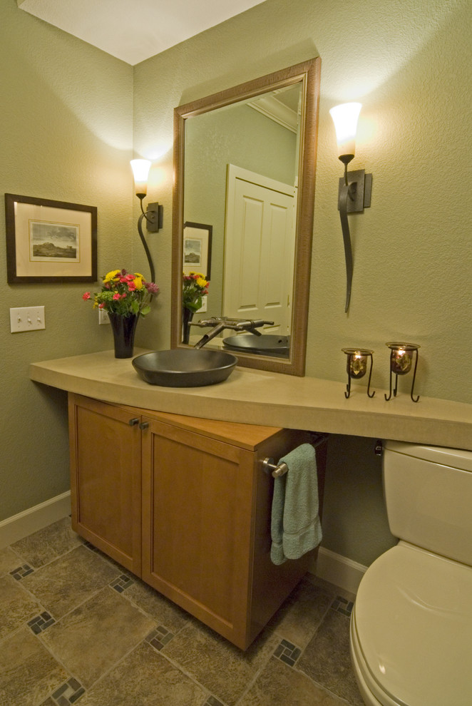 Mid-sized contemporary bathroom in Denver with a wall-mount sink, shaker cabinets, medium wood cabinets, concrete benchtops, a two-piece toilet, brown tile, porcelain tile, green walls and porcelain floors.