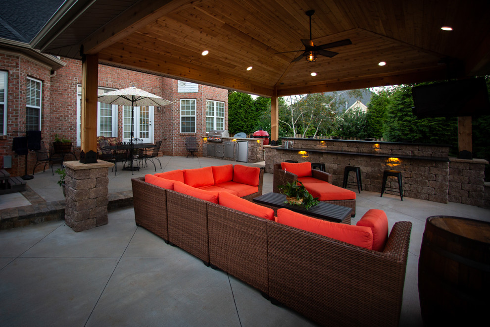 Mid-sized eclectic backyard patio in Other with an outdoor kitchen and stamped concrete.