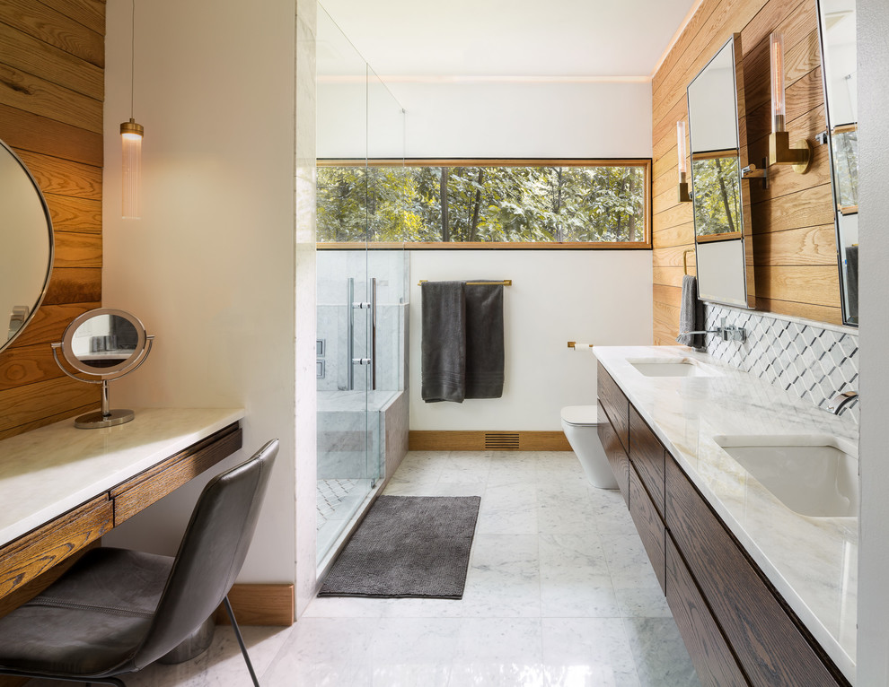 Photo of a contemporary bathroom in Atlanta with flat-panel cabinets, dark wood cabinets, an alcove shower, white tile, white walls, an undermount sink, white floor and a hinged shower door.
