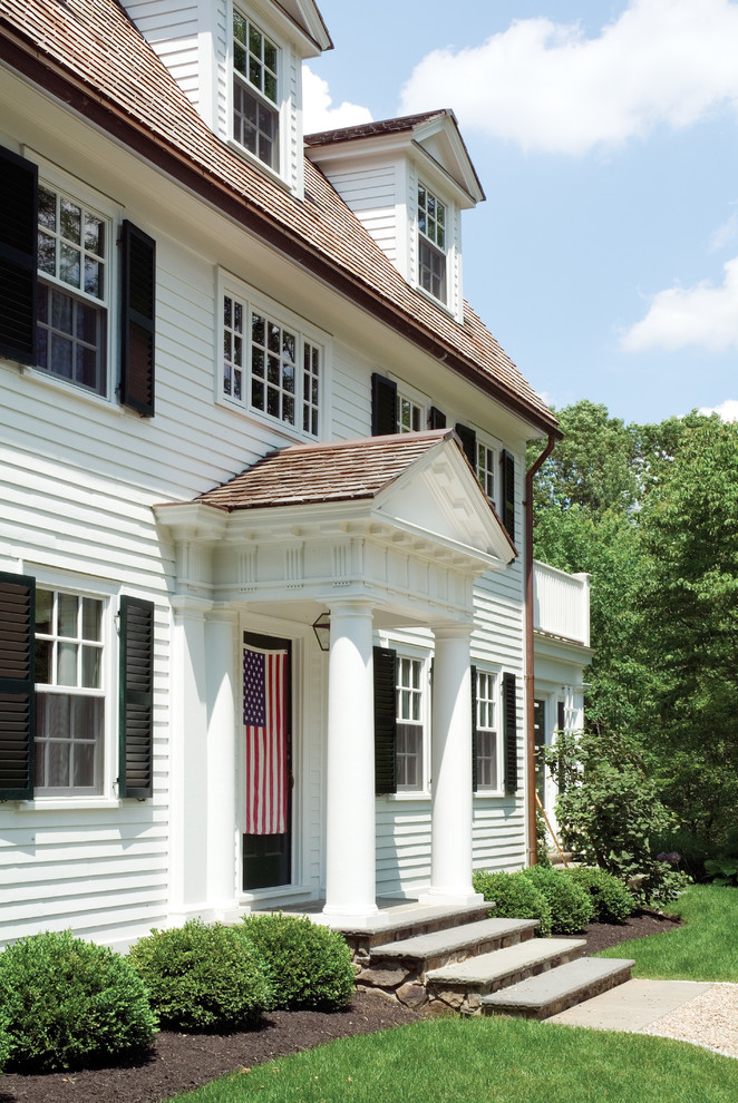 Design ideas for a large traditional two-storey white exterior in Boston with wood siding and a gambrel roof.