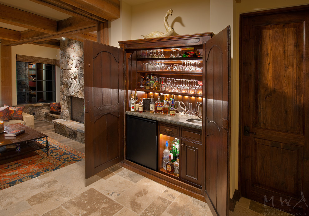 Design ideas for a large country home bar in Other with dark wood cabinets, travertine floors and multi-coloured floor.