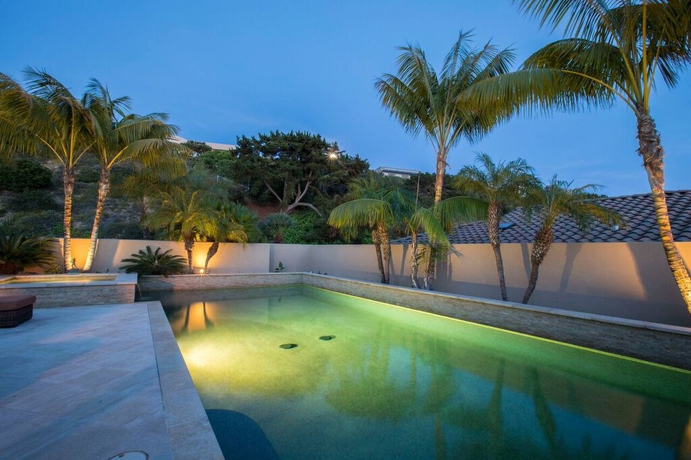 Photo of a large contemporary backyard rectangular pool in San Diego with a hot tub and concrete slab.