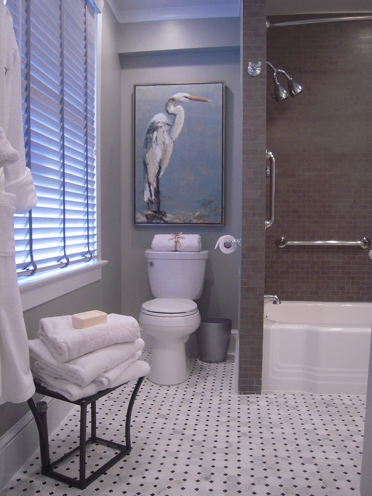 This is an example of a small traditional master bathroom in DC Metro with an undermount sink, furniture-like cabinets, grey cabinets, marble benchtops, a drop-in tub, a shower/bathtub combo, a two-piece toilet, white tile, porcelain tile, grey walls and marble floors.