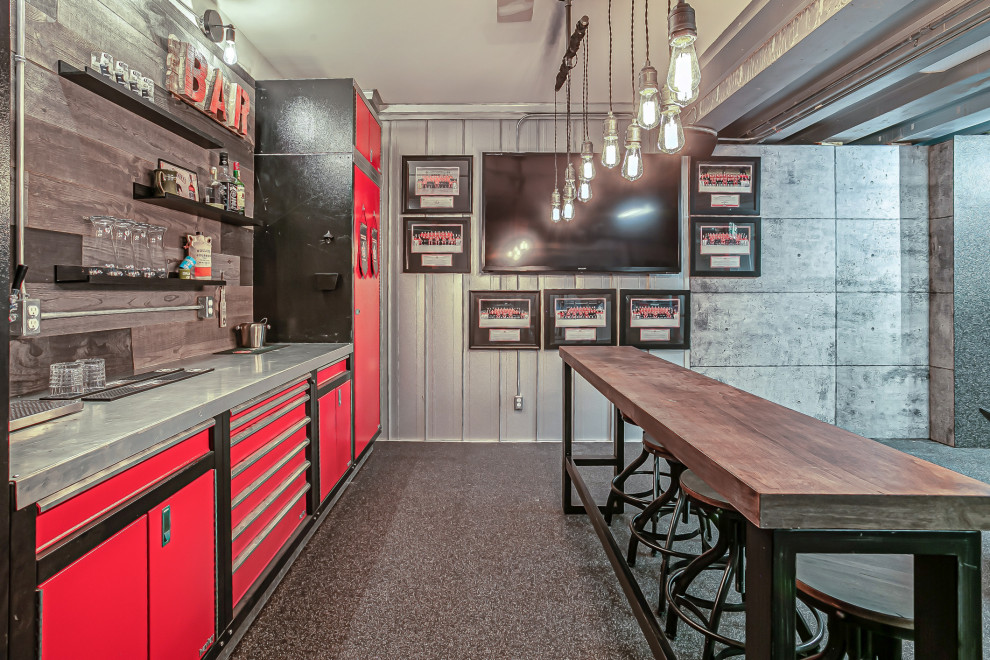 Inspiration for a mid-sized industrial home bar in Calgary with shiplap splashback, cork floors and grey floor.