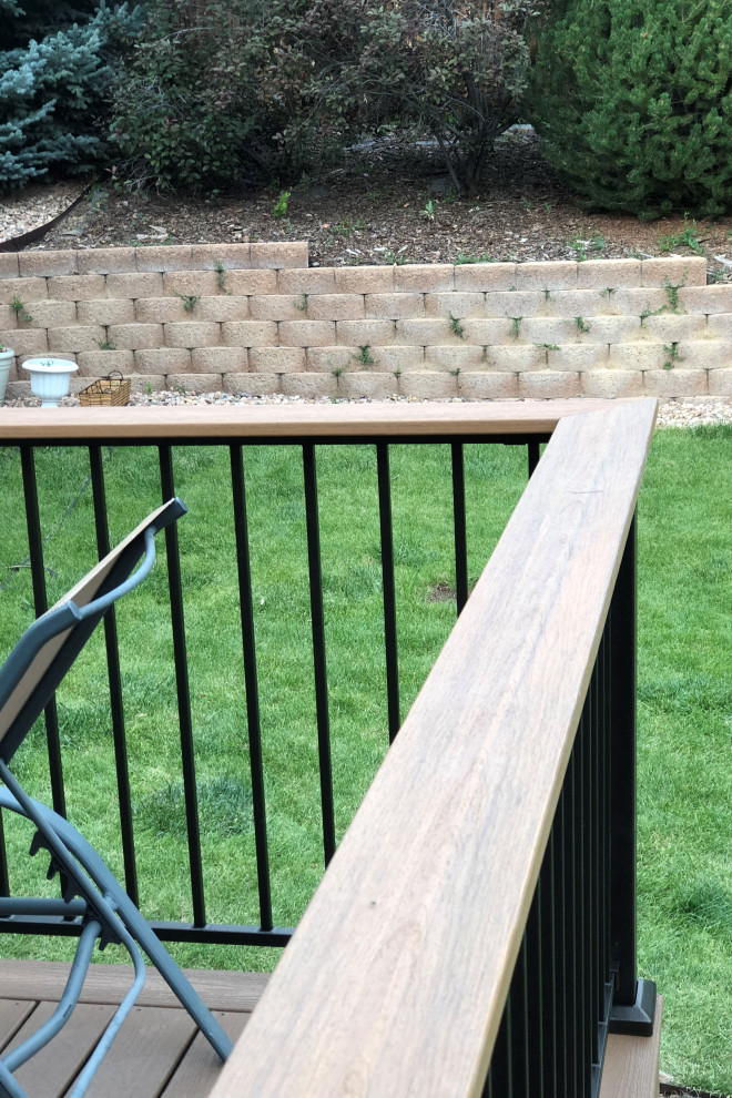 Example of a mid-sized backyard second story mixed material railing deck design with no cover