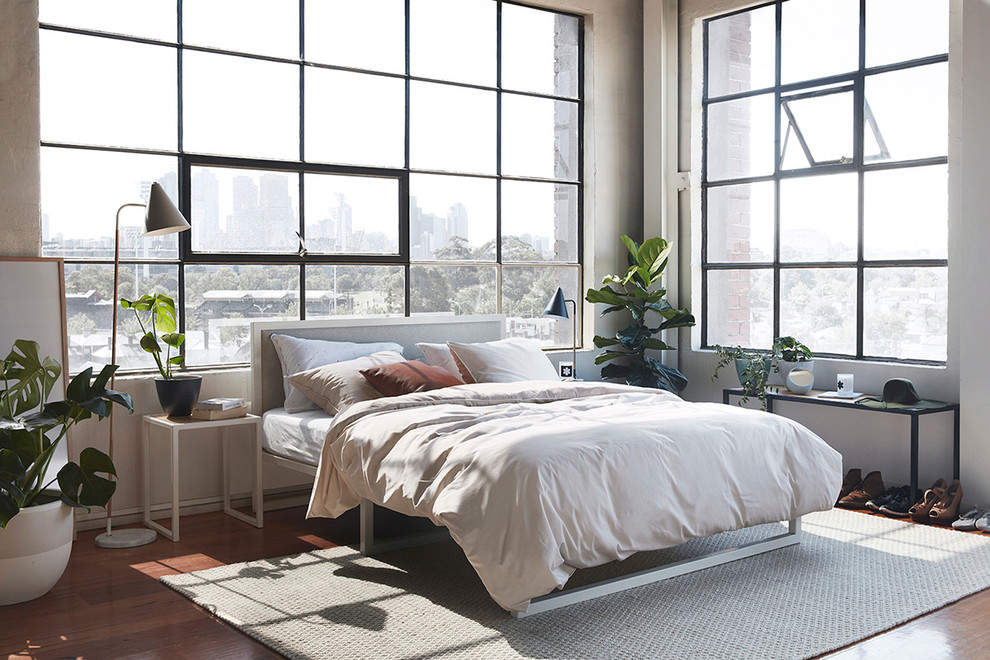 Photo of a large industrial bedroom in Melbourne with white walls.