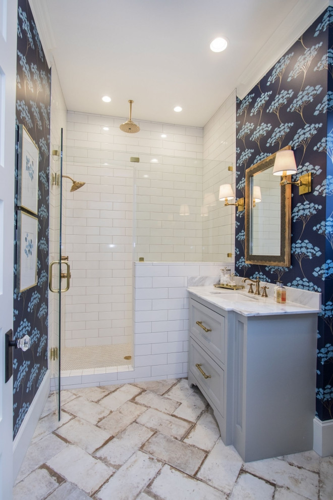 Inspiration for a country bathroom in Houston with recessed-panel cabinets, grey cabinets, an alcove shower, white tile, subway tile, blue walls, an undermount sink, beige floor, a hinged shower door and white benchtops.