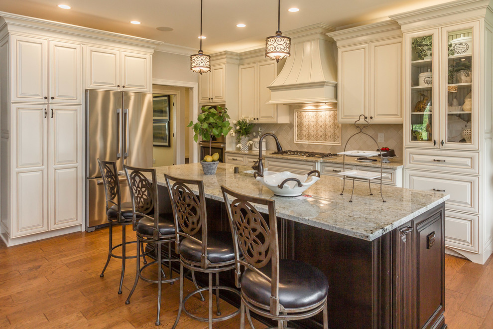 Inspiration for a traditional u-shaped kitchen in Louisville with raised-panel cabinets and with island.