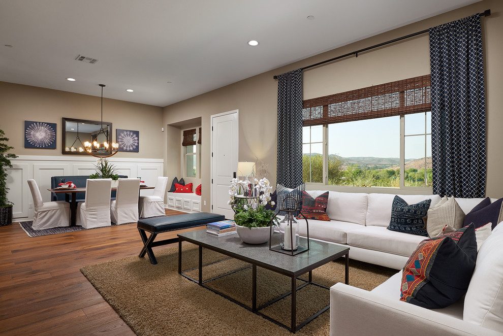 Large transitional open concept living room in San Diego with beige walls, medium hardwood floors and no fireplace.