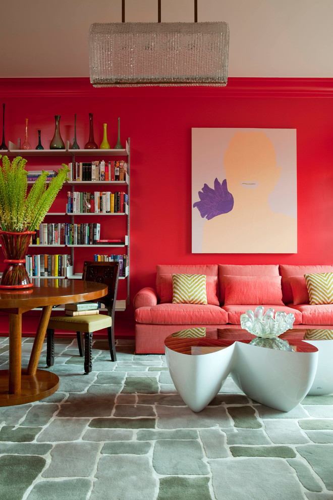 Photo of a contemporary open concept living room in New York with a library, pink walls, no fireplace and no tv.