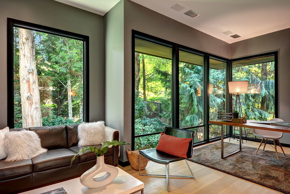 Contemporary family room in Seattle with grey walls and medium hardwood floors.