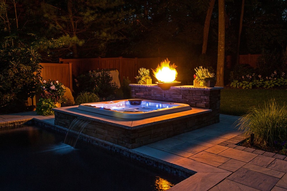 Inspiration for a pool in New York with a hot tub.