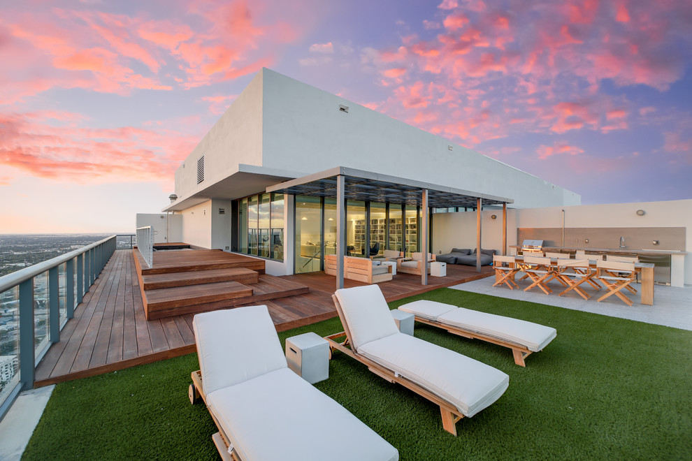 Photo of a modern rooftop and rooftop deck in Miami with an outdoor kitchen and no cover.