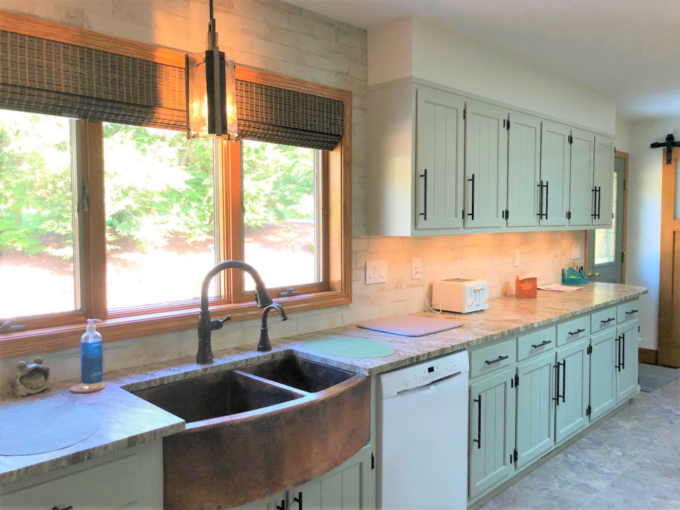 Mid-sized country l-shaped eat-in kitchen in Other with a farmhouse sink, beaded inset cabinets, green cabinets, granite benchtops, white splashback, vinyl floors, grey floor and brown benchtop.