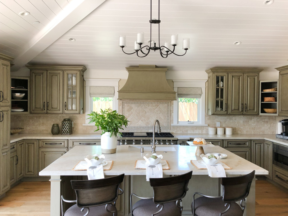 Design ideas for a traditional u-shaped kitchen in Santa Barbara with an undermount sink, raised-panel cabinets, green cabinets, beige splashback, stainless steel appliances, medium hardwood floors, with island, blue floor, beige benchtop, timber and vaulted.