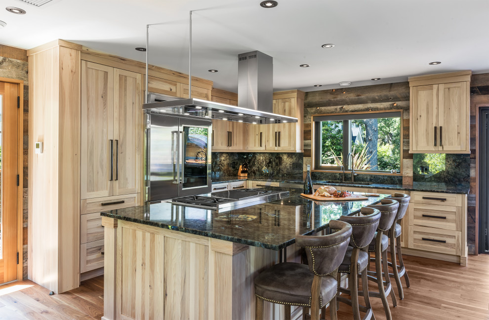 Inspiration for a mid-sized rustic l-shaped medium tone wood floor and brown floor eat-in kitchen remodel with an undermount sink, shaker cabinets, light wood cabinets, granite countertops, multicolored backsplash, granite backsplash, stainless steel appliances, an island and multicolored countertops