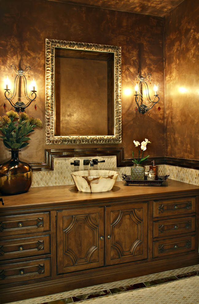 This is an example of a traditional powder room in Phoenix with a vessel sink.