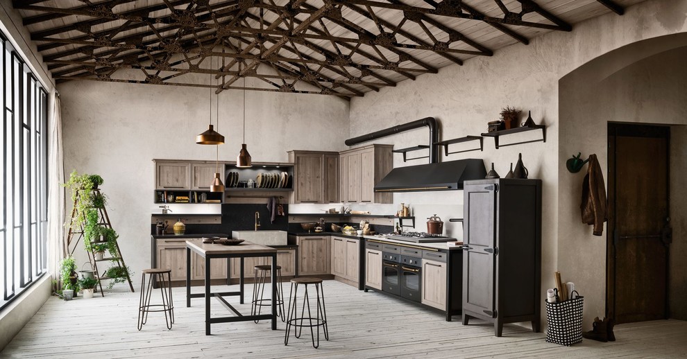 Design ideas for a large modern l-shaped open plan kitchen in Austin with a double-bowl sink, flat-panel cabinets, concrete benchtops, black splashback, cement tile splashback, panelled appliances, light hardwood floors, with island, brown floor and black benchtop.