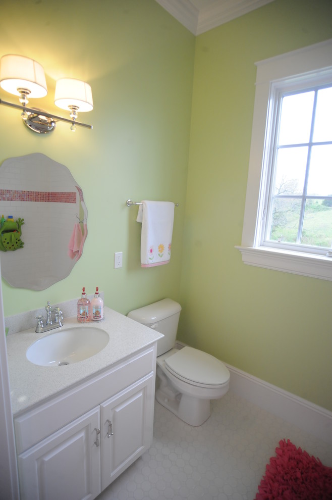 Photo of a small country bathroom in Other with an undermount sink, raised-panel cabinets, white cabinets, marble benchtops, an alcove tub, a shower/bathtub combo, a two-piece toilet, white tile, porcelain tile, green walls and porcelain floors.