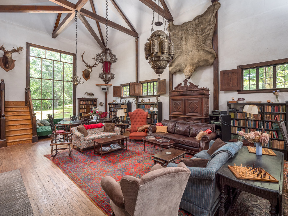 Inspiration for an expansive country open concept family room in Portland Maine with white walls, medium hardwood floors, a standard fireplace and a brick fireplace surround.