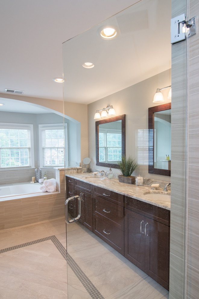 Large contemporary master bathroom in DC Metro with an undermount sink, recessed-panel cabinets, dark wood cabinets, granite benchtops, a drop-in tub, an alcove shower, a two-piece toilet, beige tile, porcelain tile, beige walls and porcelain floors.