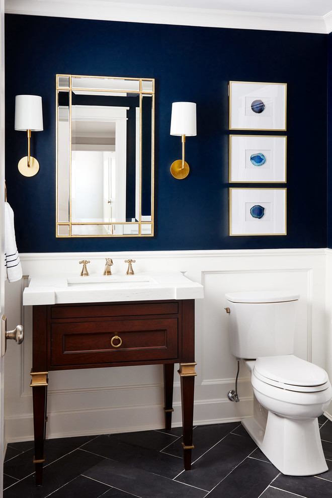 Small transitional gray floor and porcelain tile powder room photo in Chicago with furniture-like cabinets, dark wood cabinets, a two-piece toilet, blue walls, an undermount sink, marble countertops and white countertops