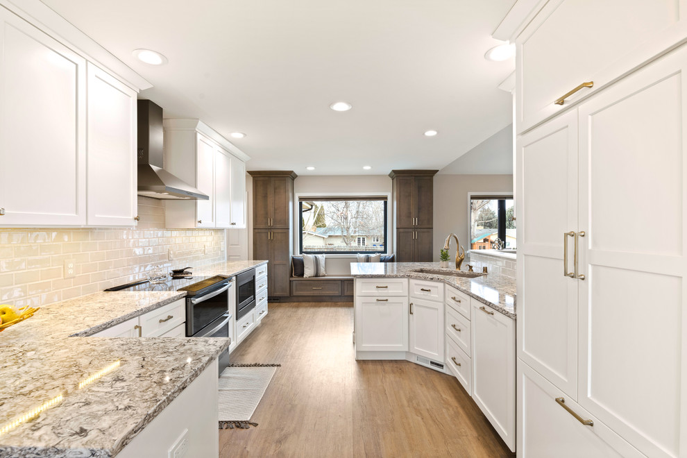 Mid-sized transitional galley brown floor eat-in kitchen photo with an undermount sink, shaker cabinets, white cabinets, quartz countertops, ceramic backsplash and black appliances