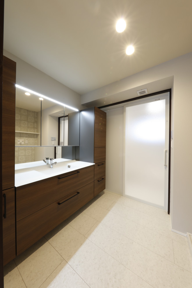 Small contemporary powder room in Other with furniture-like cabinets, brown cabinets, white tile, marble, white walls, marble floors, an undermount sink, solid surface benchtops, white floor, white benchtops, a built-in vanity, wallpaper and wallpaper.