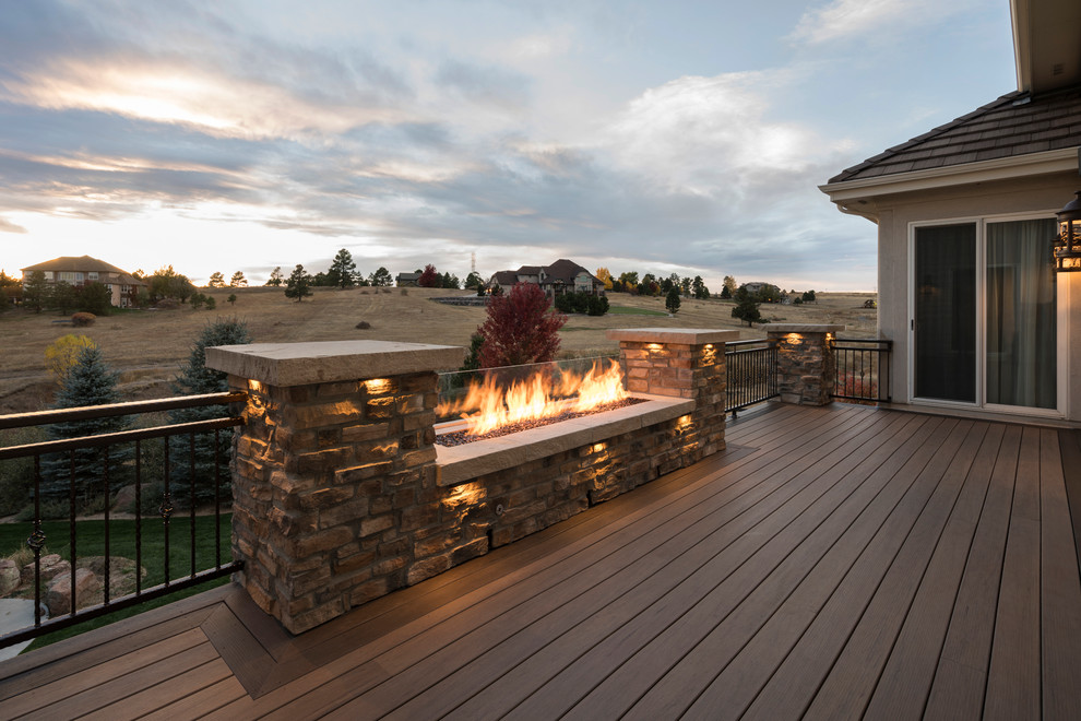 Design ideas for an arts and crafts backyard deck in Denver with a fire feature.