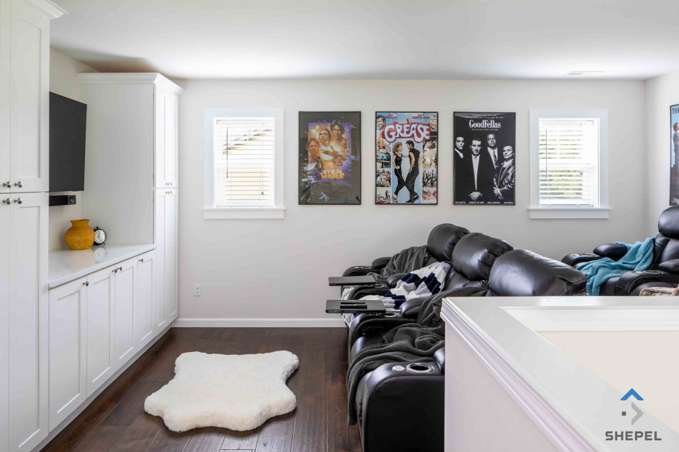 Exempel på ett litet klassiskt avskild hemmabio, med vita väggar, mörkt trägolv, en väggmonterad TV och brunt golv