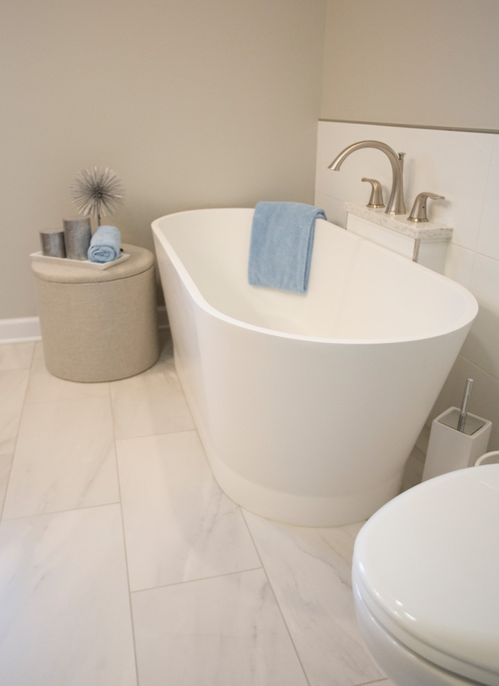 Transitional master bathroom in Chicago with raised-panel cabinets, medium wood cabinets, a freestanding tub, an open shower, a two-piece toilet, white tile, porcelain tile, porcelain floors, an undermount sink, engineered quartz benchtops, white floor and a hinged shower door.