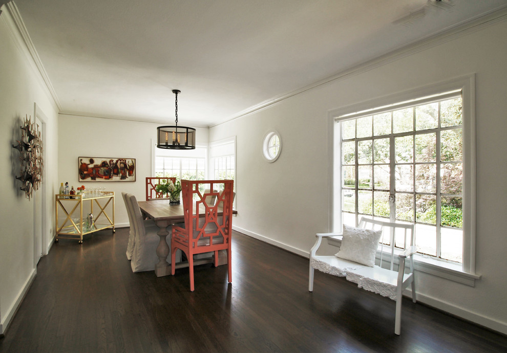 This is an example of a small eclectic dining room in Los Angeles with white walls and dark hardwood floors.