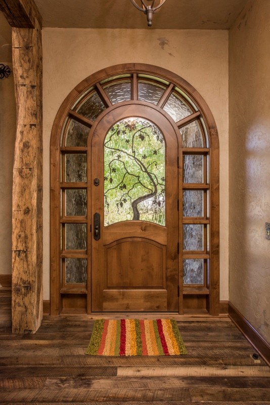 Example of a mid-sized mountain style dark wood floor front door design