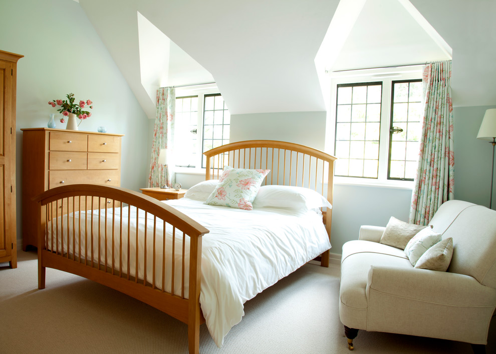 Design ideas for a traditional bedroom in Surrey with grey walls and carpet.