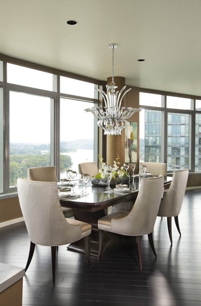 This is an example of a contemporary dining room in Portland with dark hardwood floors.