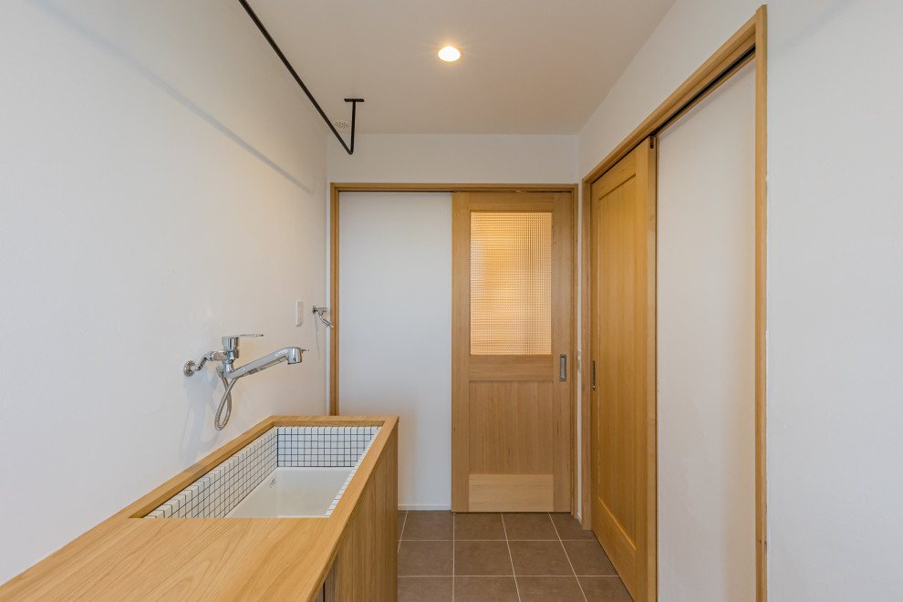 Multifunktionaler, Mittelgroßer Moderner Hauswirtschaftsraum mit weißer Wandfarbe, Porzellan-Bodenfliesen und grauem Boden in Kobe
