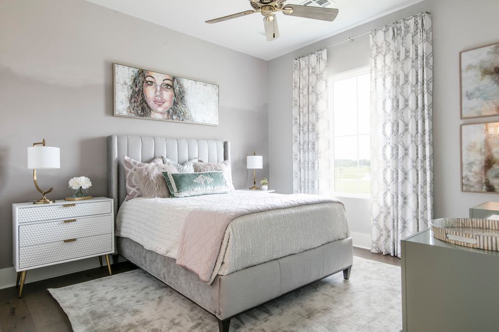 Example of a mid-sized transitional guest medium tone wood floor and brown floor bedroom design in New Orleans with beige walls and no fireplace