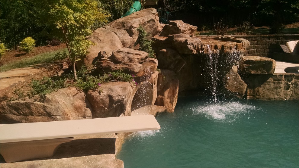 Inspiration for a large transitional backyard stone and custom-shaped water slide remodel in Charlotte