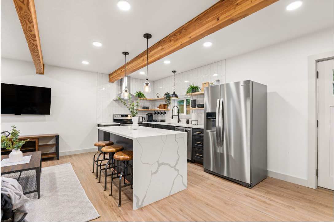 This project was a double bay garage that we converted to a complete 1 bedroom 2 bathroom home with a very modern finish. We did a L shaped kitchen with 1 island, Quartz countertops with a vertical 1/